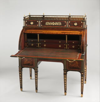 View of a marquetry rolltop desk with cylinder open showing interior fittings