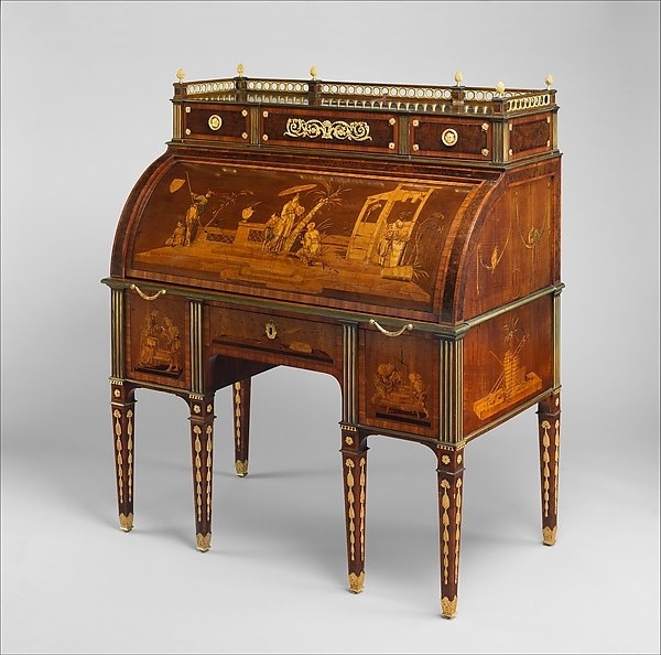 Front view of a marquetry rolltop desk with cylinder closed